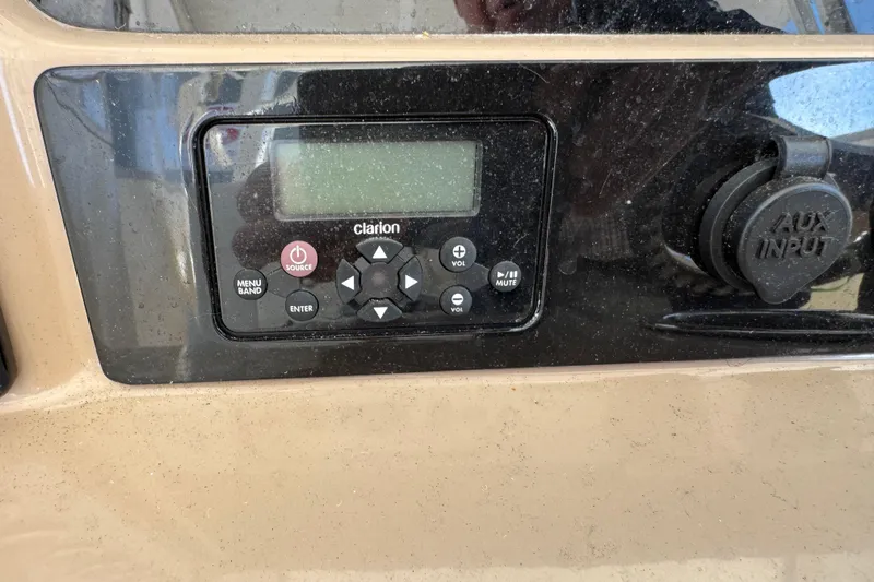 Slide: The Image of Control panel of a 2019 Robalo R272 Center Console boat with Clarion audio system. - 15