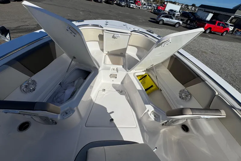 Slide: The Image of 2019 Robalo R272 Center Console boat with open storage compartments and seating. - 18
