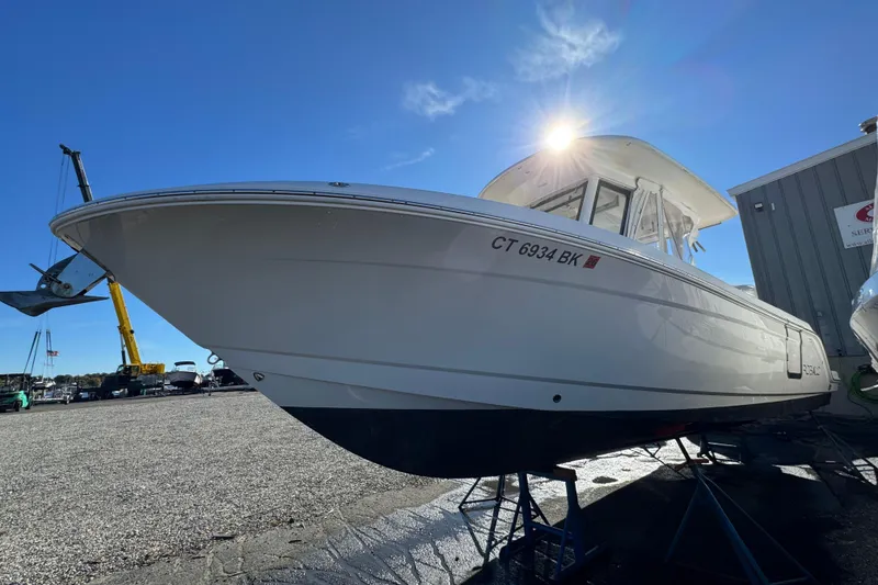 Slide: The Image of 2019 Robalo R272 Center Console boat on display under clear blue sky. - 2