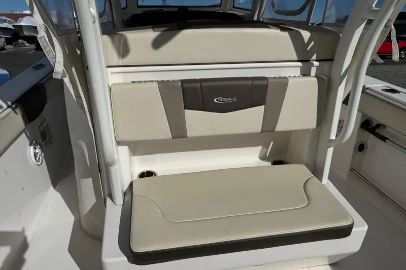 Slide: The Image of 2019 Robalo R272 Center Console boat seating area with beige and black upholstery. - 6