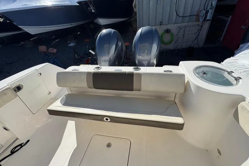 Slide: The Image of 2019 Robalo R272 Center Console boat interior with dual engines and seating area. - 7