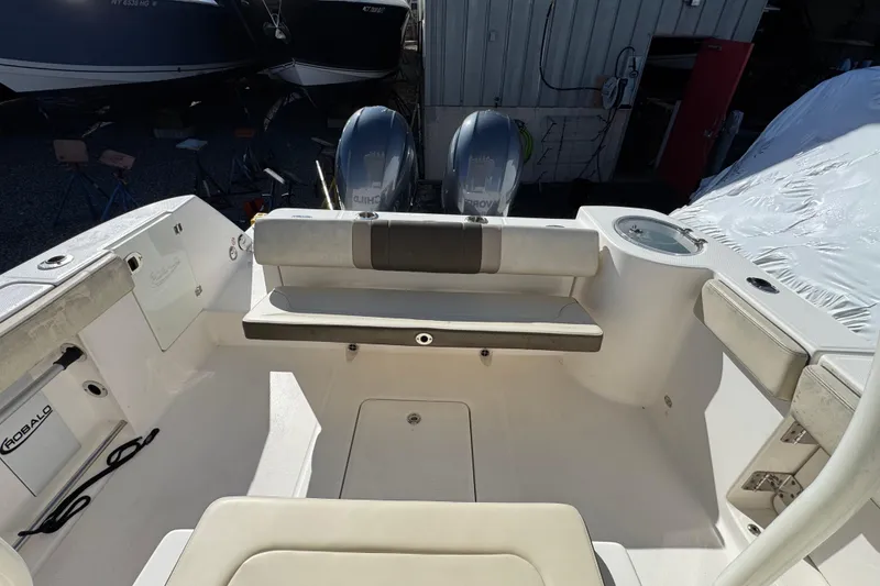 Slide: The Image of 2019 Robalo R272 Center Console boat interior with dual engines and seating area. - 8