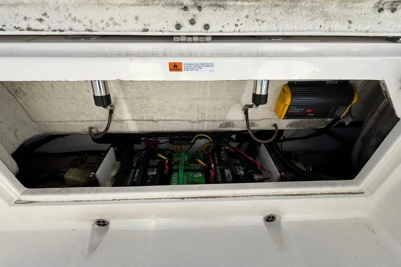 Slide: The Image of 2019 Robalo R272 Center Console battery compartment with wiring and charger. - 9