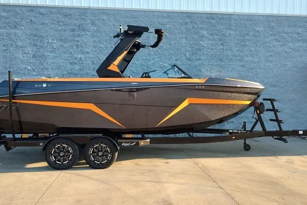 The Image of 2026 Tigé Z3 boat with sleek black and orange design on a trailer. - 1