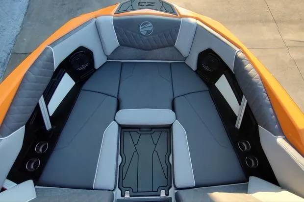 Slide: The Image of 2026 Tigé Z3 boat interior with orange and gray seating, featuring cup holders and speakers. - 4