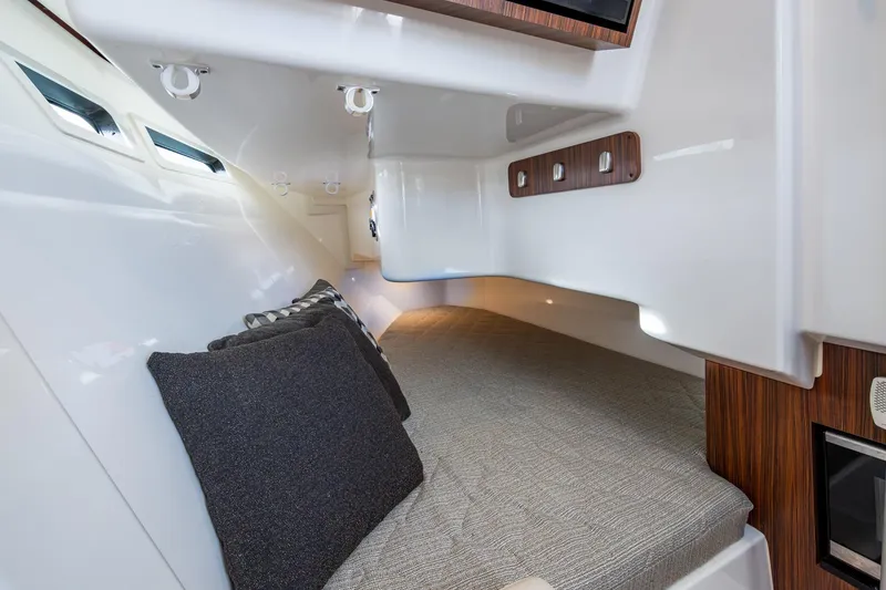 Slide: The Image of 2019 Pursuit DC 365 Dual Console cabin interior with cozy bedding and modern design. - 11