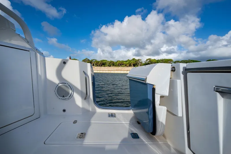 Slide: The Image of 2019 Pursuit DC 365 Dual Console boat interior with open water view. - 16