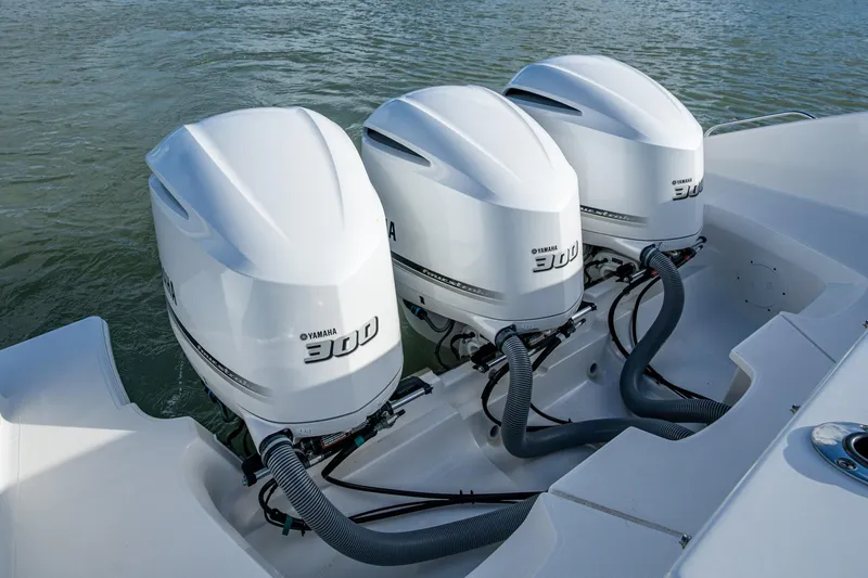 Slide: The Image of Triple Yamaha 300 engines on 2019 Pursuit DC 365 Dual Console boat. - 24