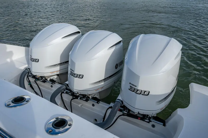 Slide: The Image of Triple Yamaha 300 outboard engines on a 2019 Pursuit DC 365 Dual Console boat. - 26