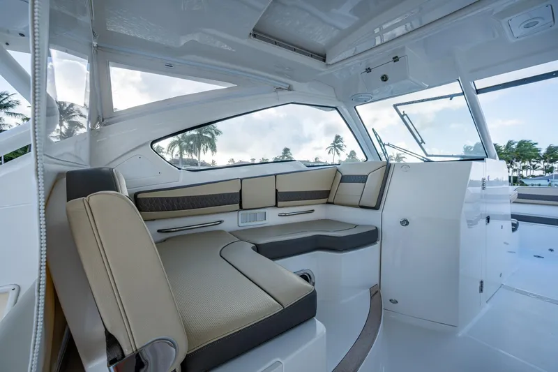 Slide: The Image of 2019 Pursuit DC 365 Dual Console interior with beige seating and panoramic windows. - 30