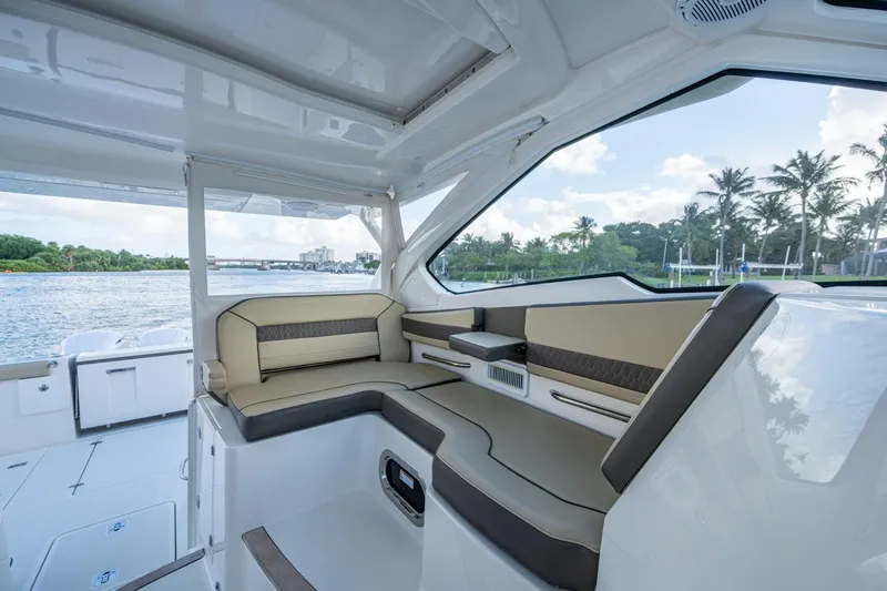 Slide: The Image of 2019 Pursuit DC 365 Dual Console interior with luxurious seating and scenic water view. - 31