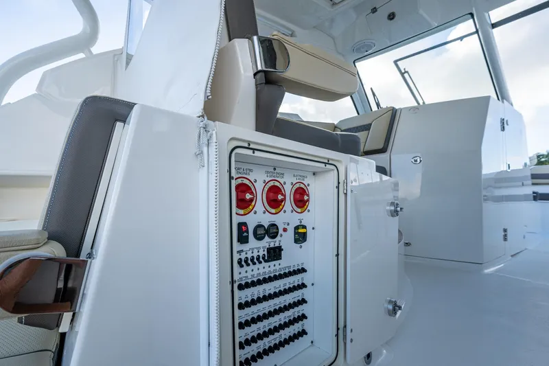 Slide: The Image of 2019 Pursuit DC 365 Dual Console boat interior with control panel and seating. - 32