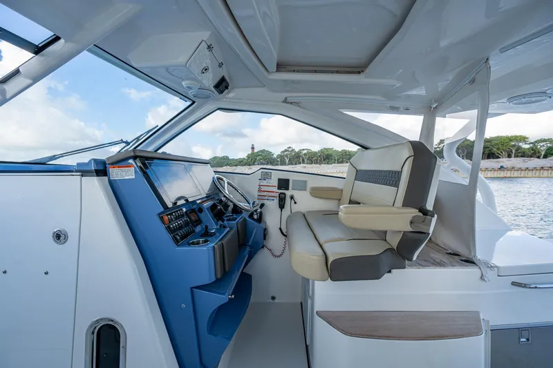 Slide: The Image of 2019 Pursuit DC 365 Dual Console boat interior with helm and seating. - 33