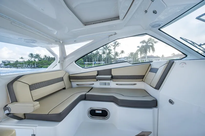 Slide: The Image of 2019 Pursuit DC 365 Dual Console interior with luxurious seating and scenic waterfront view. - 38