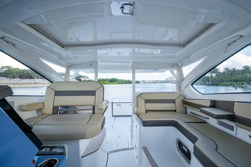 Slide: The Image of 2019 Pursuit DC 365 Dual Console interior with spacious seating and scenic water view. - 39