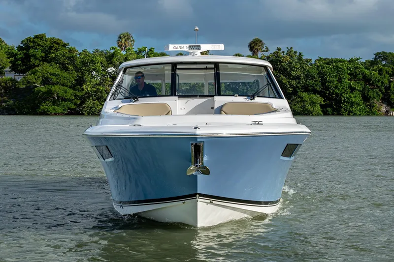 Slide: The Image of 2019 Pursuit DC 365 Dual Console boat cruising on a scenic waterway. - 52