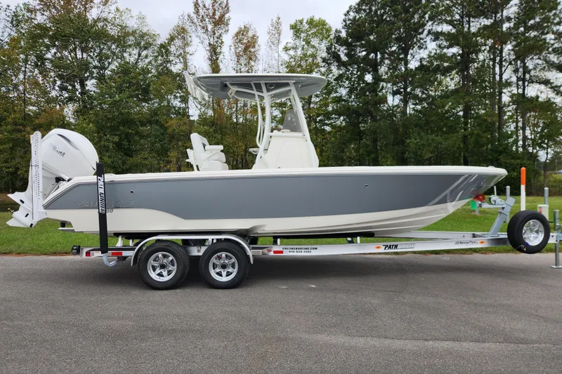 The Image of 2026 Pathfinder 2400 TRS boat on trailer, parked outdoors with trees in background. - 0