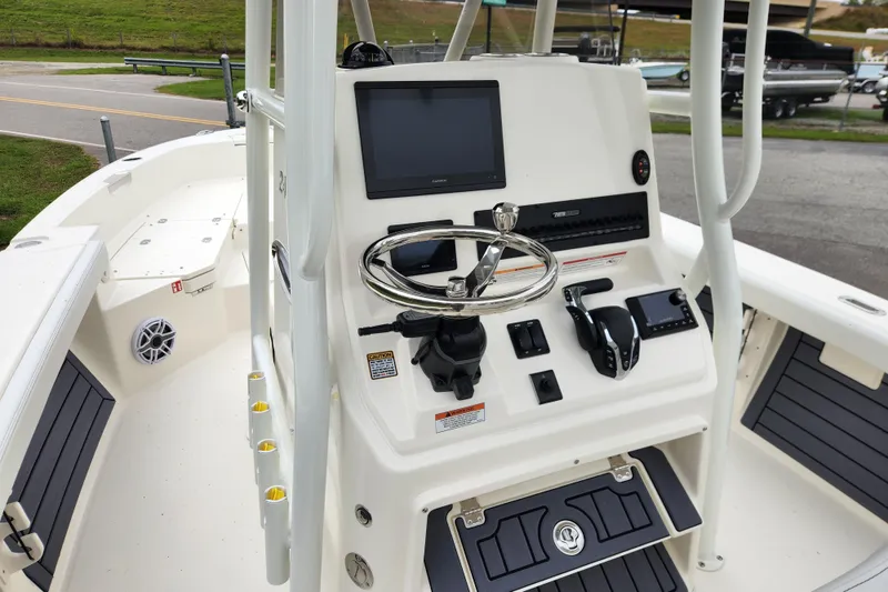 Slide: The Image of 2026 Pathfinder 2400 TRS boat console with steering wheel and electronic controls. - 10