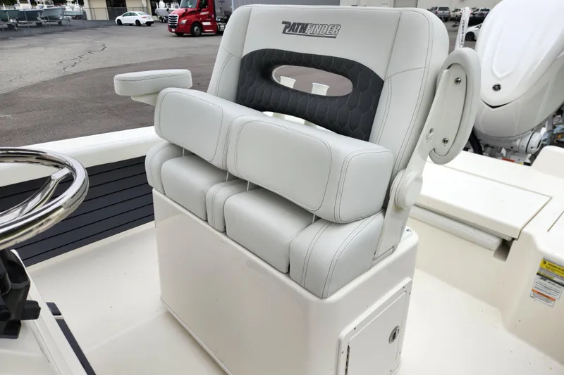 Slide: The Image of 2026 Pathfinder 2400 TRS boat seat with armrests and steering wheel. - 12