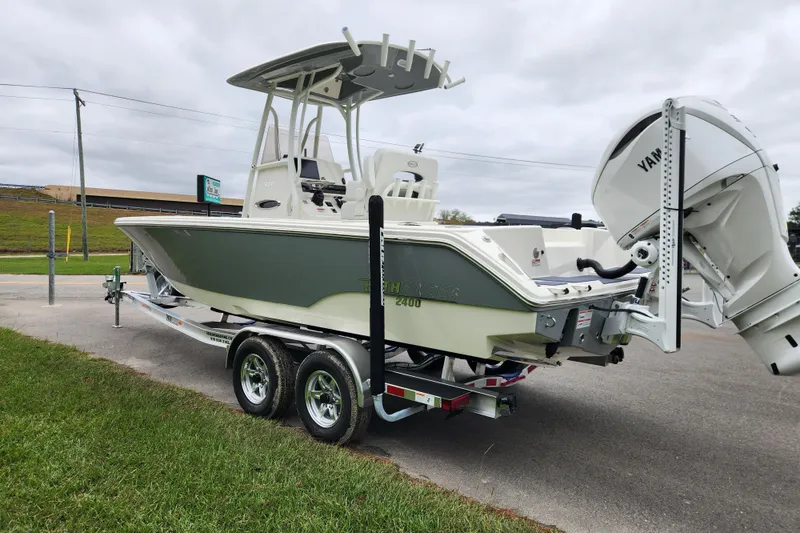Slide: The Image of 2026 Pathfinder 2400 TRS boat on trailer with Yamaha engine, parked outdoors. - 4
