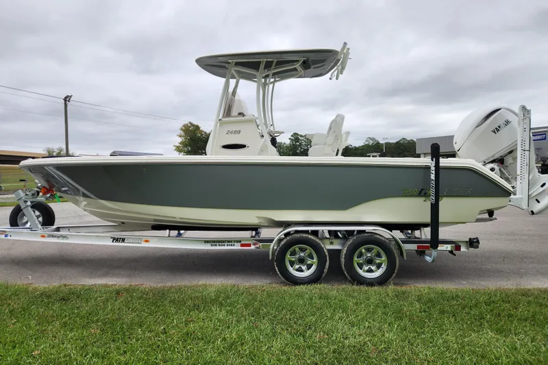 Slide: The Image of 2026 Pathfinder 2400 TRS boat on trailer, parked outdoors, side view. - 5