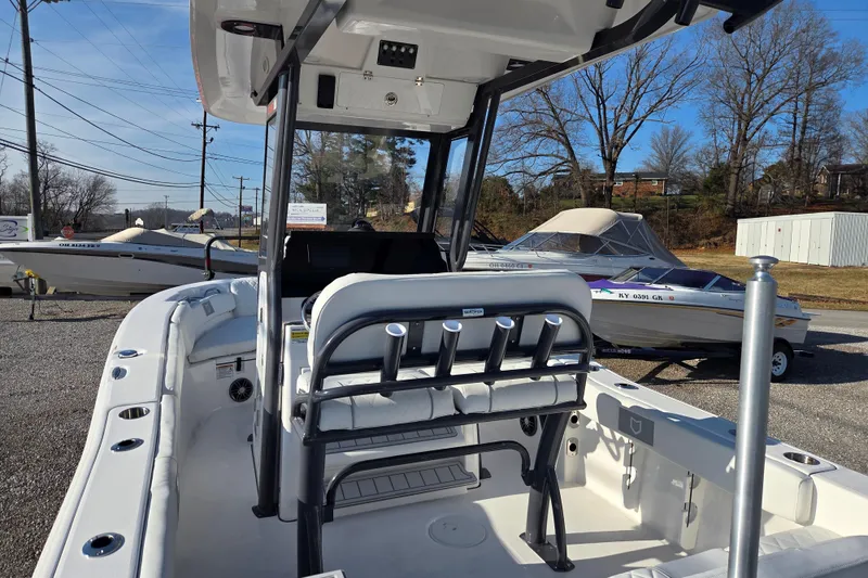 Slide: The Image of 2026 Sea Fox 228 Commander boat interior with seating and rod holders, displayed outdoors. - 10