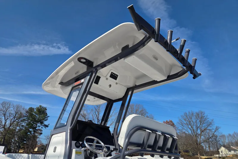 Slide: The Image of 2026 Sea Fox 228 Commander boat with T-top and rod holders against blue sky. - 12