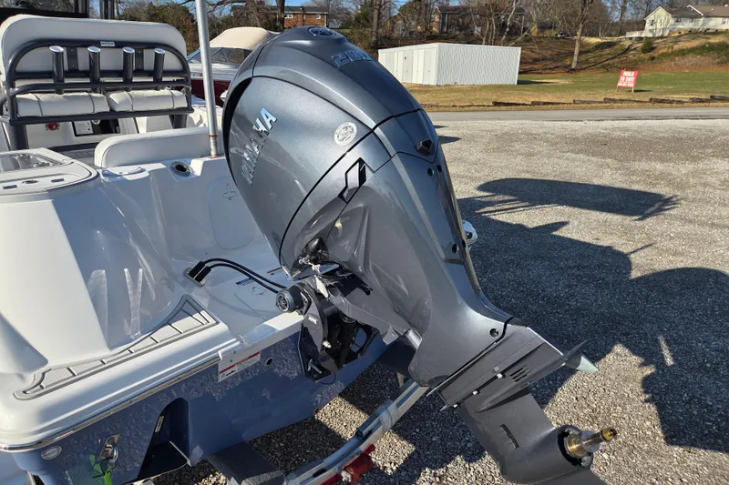 Slide: The Image of 2026 Sea Fox 228 Commander boat with Yamaha outboard motor, parked outdoors. - 3