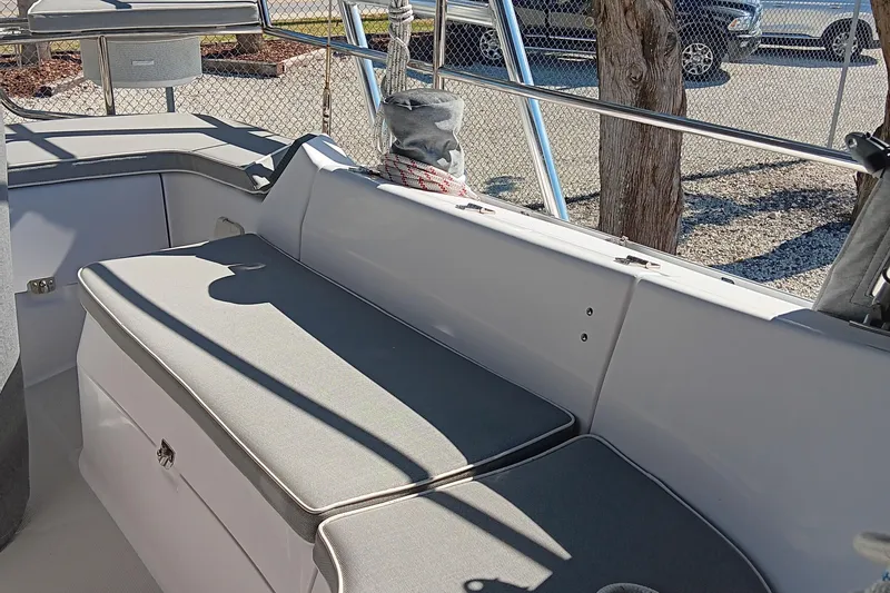 Slide: The Image of Catalina 315 2020 model boat interior with cushioned seating and storage. - 13