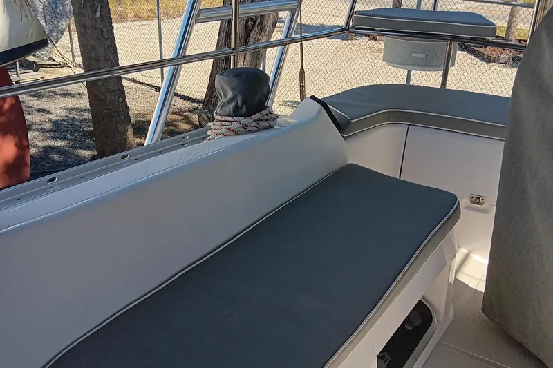 Slide: The Image of 2020 Catalina 315 boat interior seating area with grey cushions. - 14