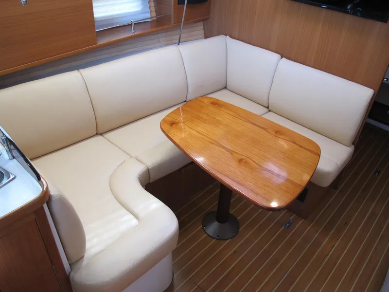 Slide: The Image of 2020 Catalina 315 yacht interior with cream leather seating and wooden table. - 17