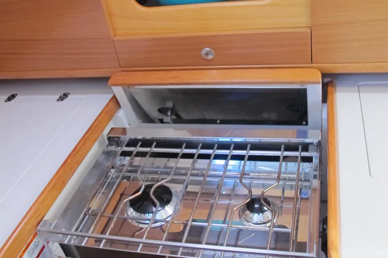 Slide: The Image of Catalina 315 2020 model yacht kitchen with a two-burner stove. - 19