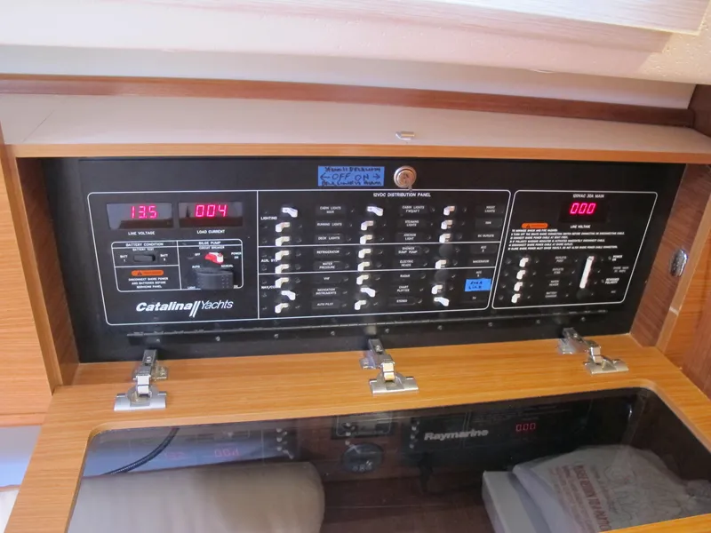 Slide: The Image of Catalina 315 2020 model electrical control panel with switches and digital displays. - 20