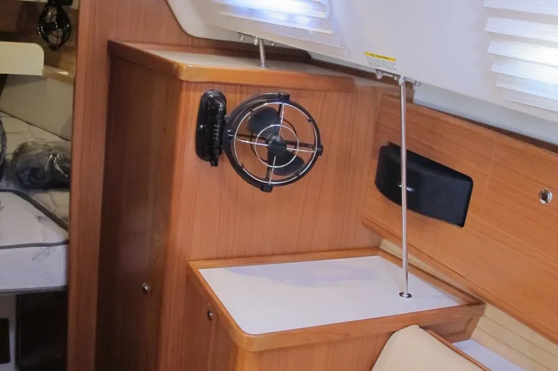 Slide: The Image of Interior of 2020 Catalina 315 sailboat with wooden cabinetry and fan. - 21
