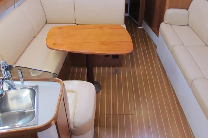 Slide: The Image of Interior of 2020 Catalina 315 sailboat with wooden table and seating. - 22