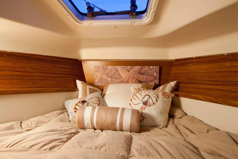 Slide: The Image of Cozy cabin bed in a 2020 Catalina 315 sailboat with nautical-themed pillows. - 28