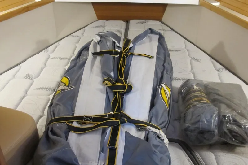 Slide: The Image of Interior of 2020 Catalina 315 sailboat with folded sails on bed. - 29