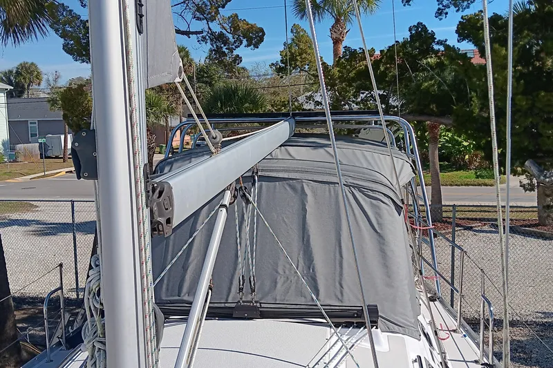 Slide: The Image of Catalina 315 sailboat, 2020 model, docked with covered cockpit and mast visible. - 3