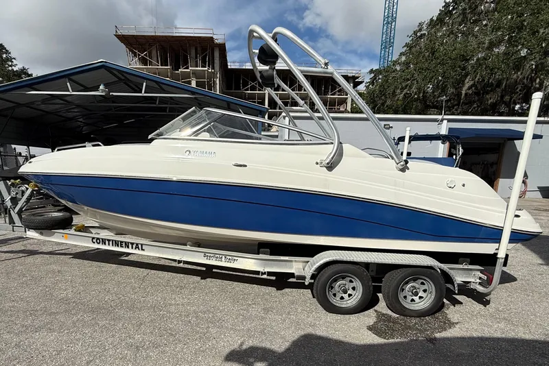 Slide: The Image of 2009 Yamaha Boats AR230 HO on trailer, blue and white, parked outdoors. - 7