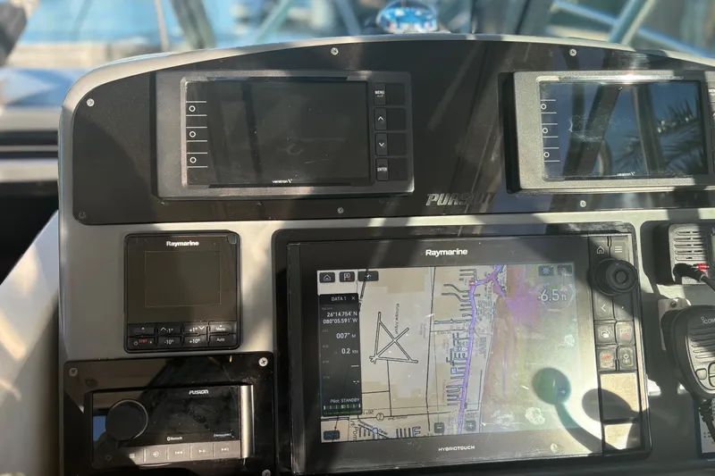 Slide: The Image of 2000 Pursuit 3400 Express yacht docked at a serene waterfront location. - 11