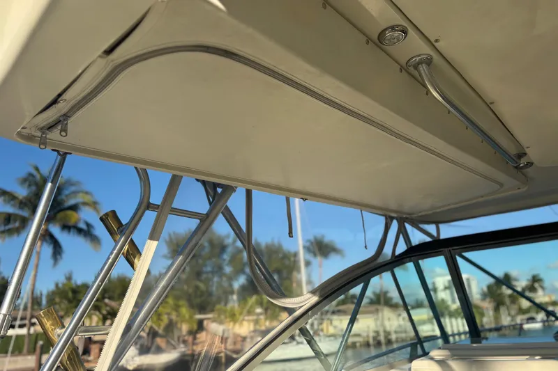 Slide: The Image of Helm of 2000 Pursuit 3400 Express boat with palm trees in background. - 16