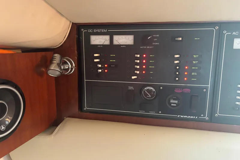 Slide: The Image of 2000 Pursuit 3400 Express boat docked by waterfront homes, clear blue sky. - 25