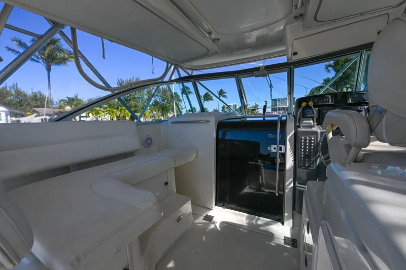 Slide: The Image of Interior of 2000 Pursuit 3400 Express boat with white seating and modern controls. - 29