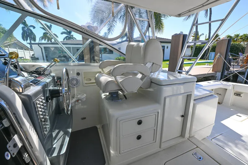 Slide: The Image of 2000 Pursuit 3400 Express boat helm with dual seats and control panel. - 31