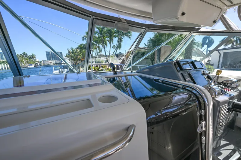 Slide: The Image of Interior view of 2000 Pursuit 3400 Express boat cockpit with modern controls and waterfront scenery. - 37