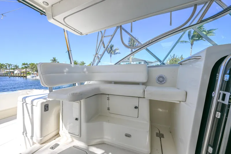Slide: The Image of 2000 Pursuit 3400 Express boat interior with white seating and waterfront view. - 38