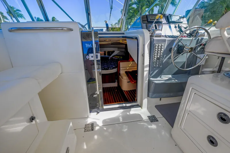 Slide: The Image of Interior view of 2000 Pursuit 3400 Express boat, featuring helm and cabin entrance. - 41
