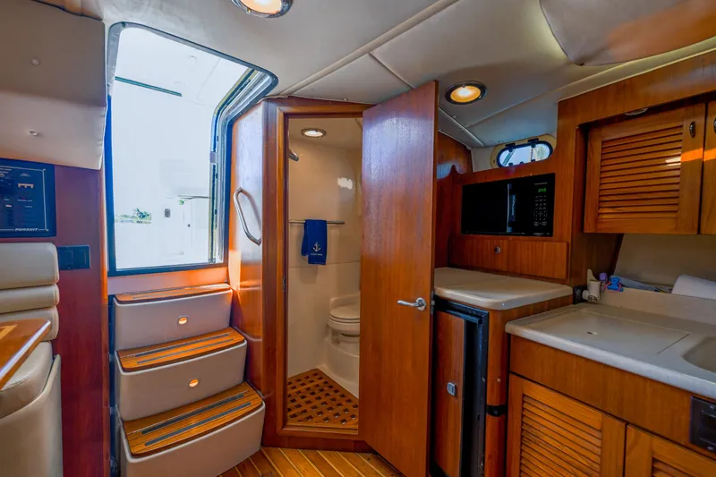 Slide: The Image of Interior of 2000 Pursuit 3400 Express boat with kitchenette and bathroom. - 42