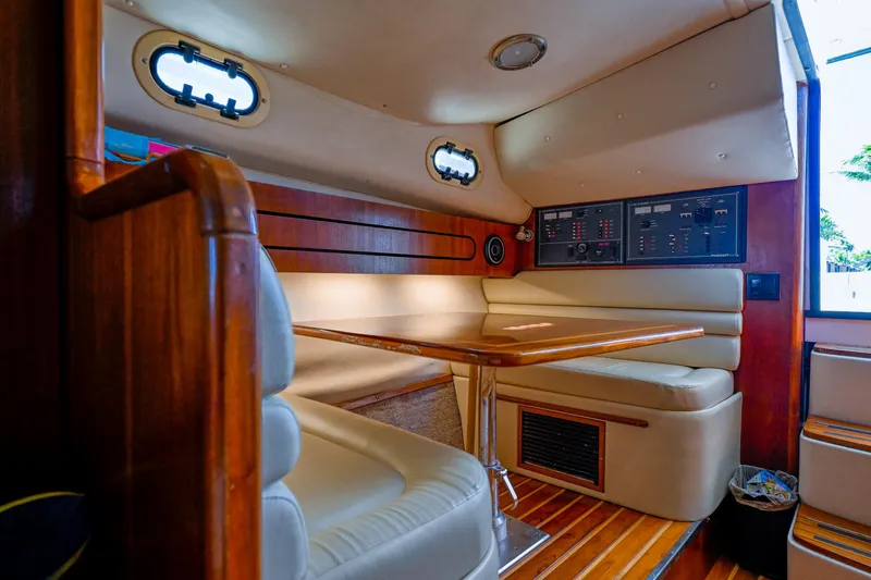 Slide: The Image of Luxurious interior of 2000 Pursuit 3400 Express yacht with wood accents and seating area. - 43