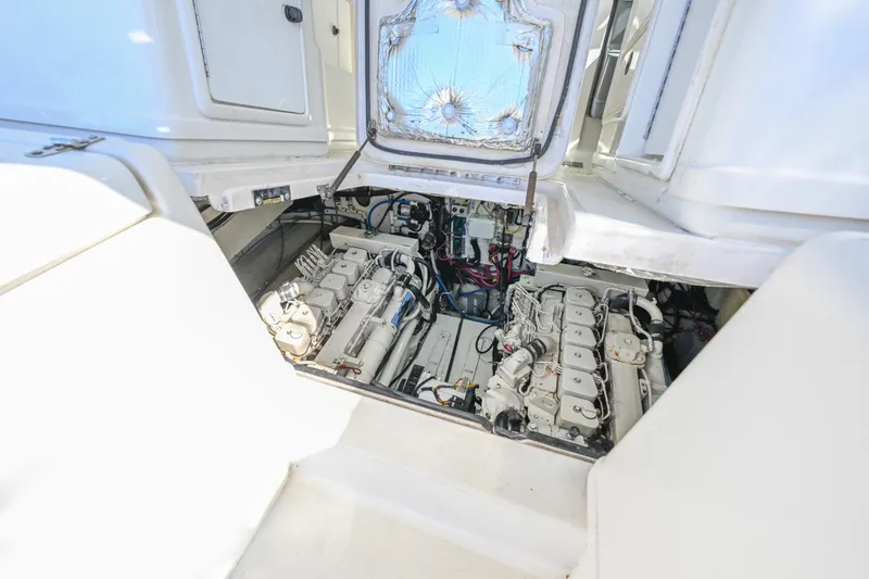 Slide: The Image of Engine compartment of a 2000 Pursuit 3400 Express boat, showcasing dual engines. - 48